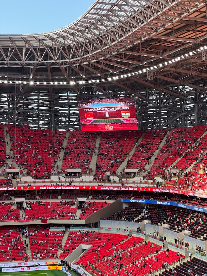 A bustling stadium during the FIFA World Cup CAF Qualifiers, showcasing vibrant crowds and electric atmosphere.